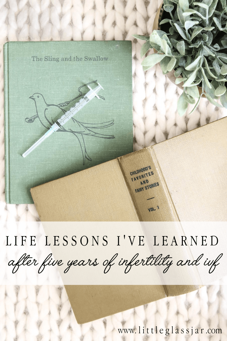 Two children's books with an IVF needle on a beautiful wool rug, signifying infertility